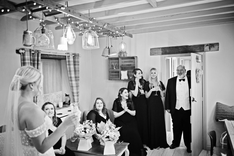 B& w image of the father of the bride seeing his daughter (bride) for the first time. Emotional in the bridal suite at Blackwell Grange.
