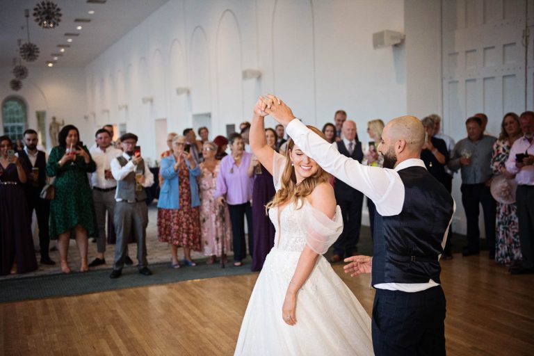 Candid photo of bride and groom doing their first dance at Margam Country Park, taken by Blooming Photography.
