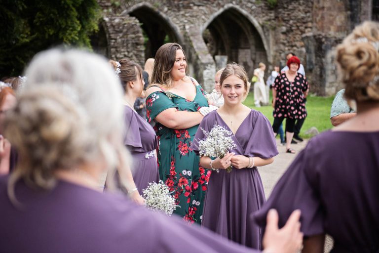 Bridesmaids wait for the bride. Photographed by Blooming Photography at Margam Country Park.