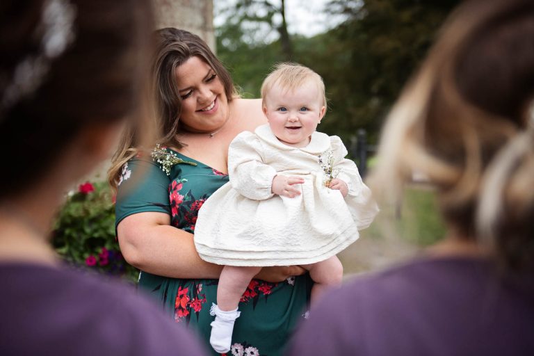 Candid pic of baby flower girl. Photographed by Blooming Photography at Margam Country Park.