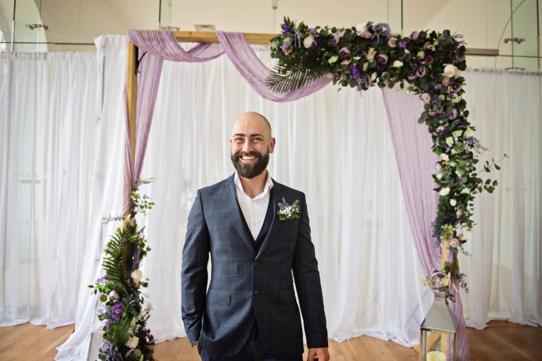 Groom waiting for his bride at Margam Country Park. Photographed by Blooming Photography