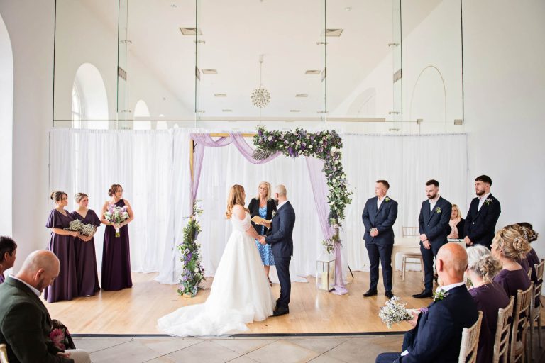 Candid photo of a wedding ceremony at Margam Country Park. Photographed by Blooming Photography