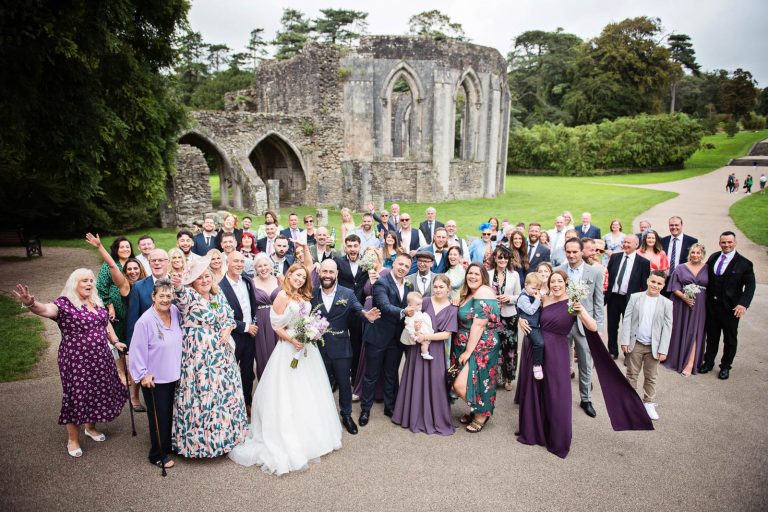 Candid wedding group photo, taken at a wedding at Margam Country Park by Blooming Photography.