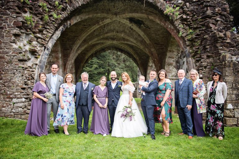 Relaxed family photo. Photo taken at a wedding at Margam Country Park by Blooming Photography.