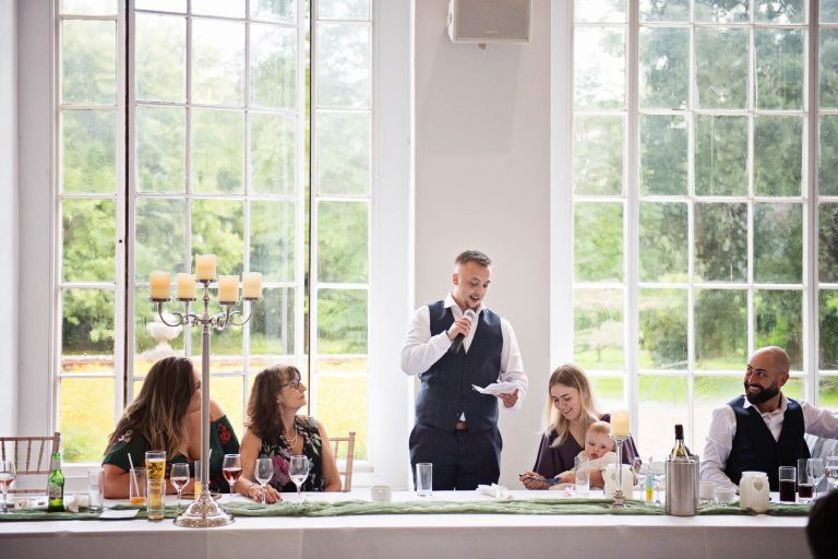 Candid image taken of best man wedding speech at Margam Country Park, during the wedding speeches by Blooming Photography.
