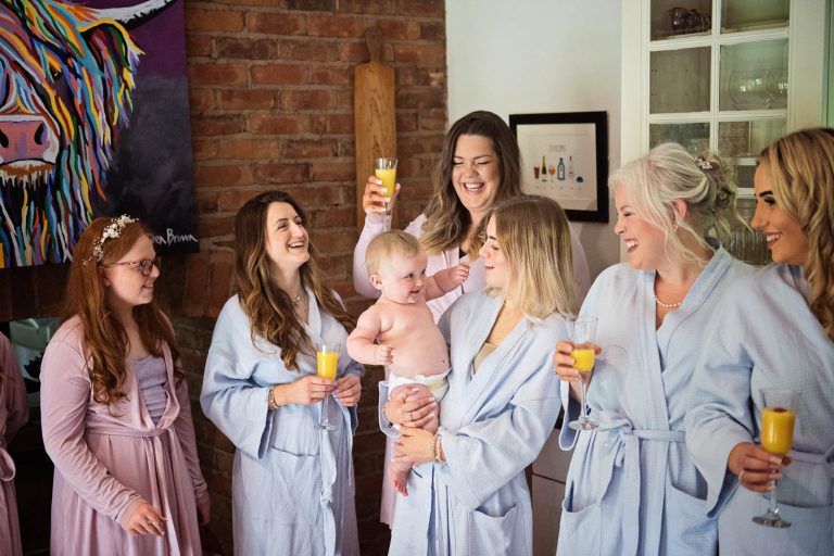 Bridesmaids cheer by Cardiff wedding photographer, Blooming Photography