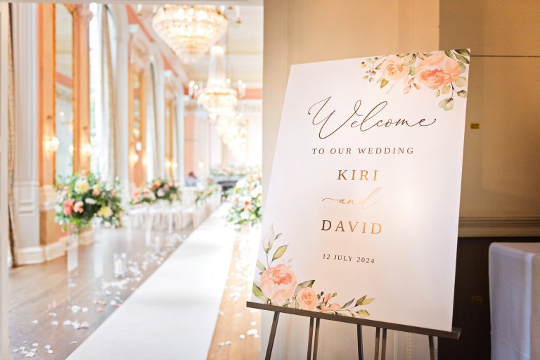 Elegant ceremony room in Danesfield House Hotel & Spa with welcome sign board welcoming guests to the wedding of Kiri & David. Photography by Blooming Photography.