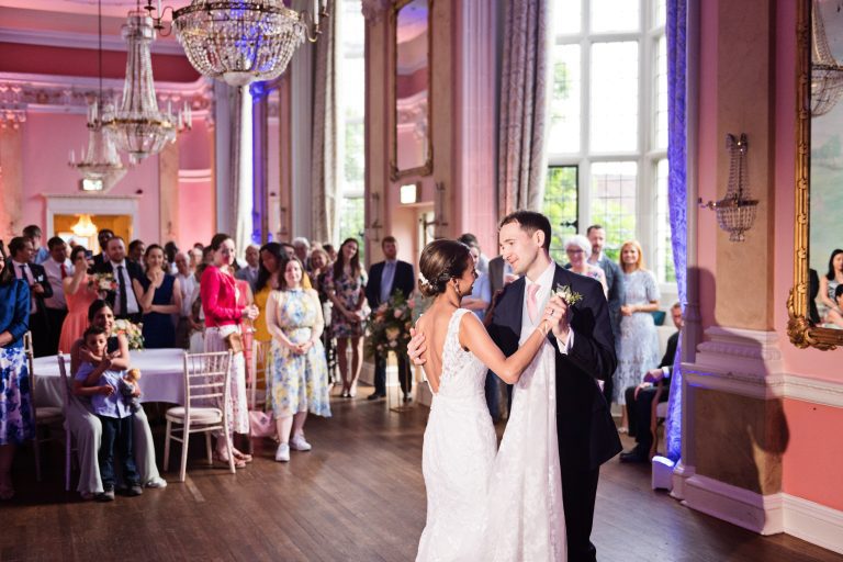 Bride and groom do their first dance. Photographed in the elegant Danesfield House Hotel and Spa Ballroom. Photograph by Ben Roberts, Blooming Photography.