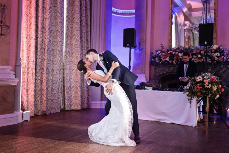 Bride and groom do their first choreographed dance including a successful "wedding dip". Photographed in the elegant Danesfield House Hotel and Spa Ballroom. Photograph by Ben Roberts, Blooming Photography.