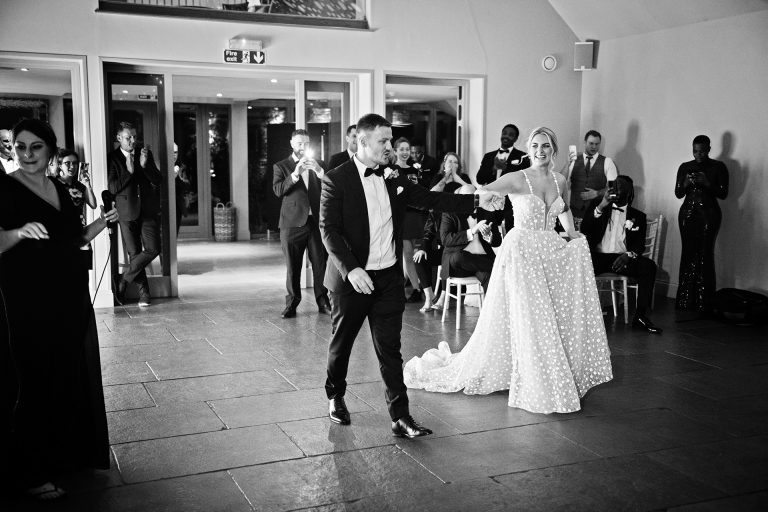 B& w image of bride and groom being announced for the first dance. Candid photo by Blooming Photography. Taken at Blackwell Grange, Warwickshire.