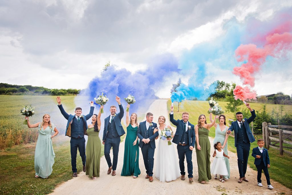 Smoke bombs at wedding at Upcote Barn, Gloucestershire. Photograph by Cheltenham wedding photographer Ben Roberts, Blooming Photography.