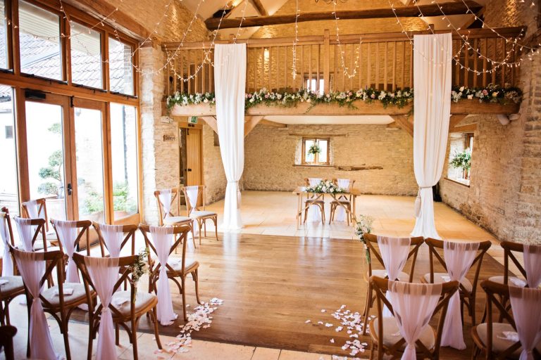 Indoor ceremony set up at Kingscote Barn.