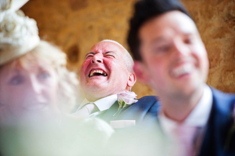 Candid moments at Kingscote Barn captured by Blooming Photography