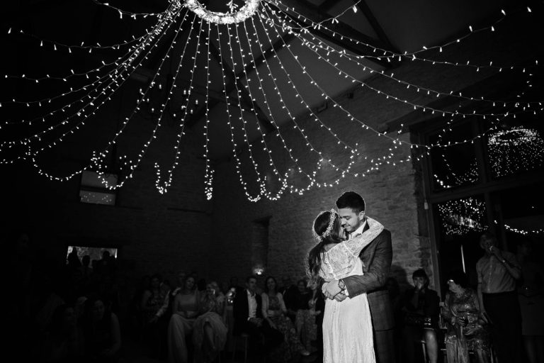 Bride and groom have a moment during first dance at Kingscote Barn
