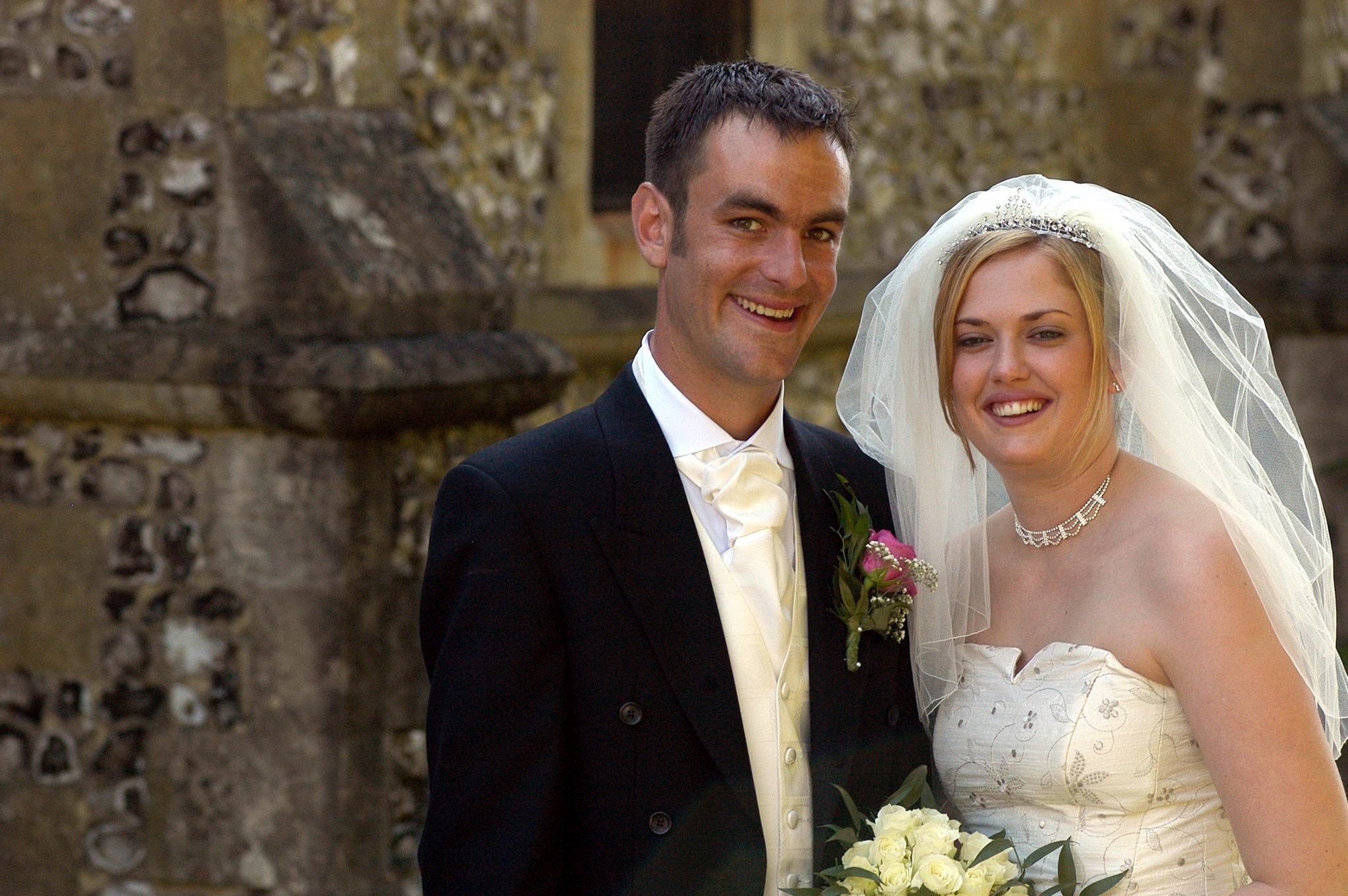 Cheltenham wedding photographer Ben Roberts Blooming Photography getting married himself in 2004 outside a church. 