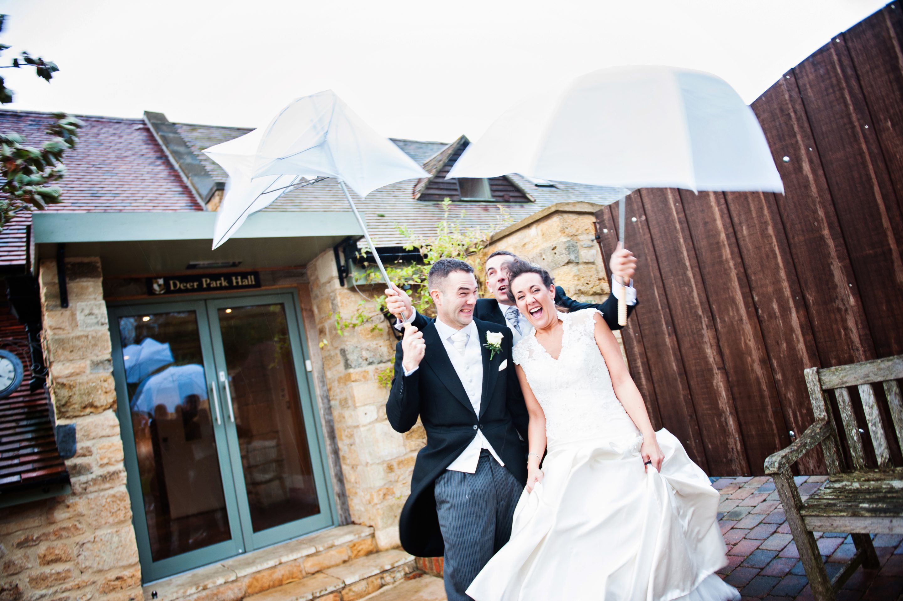 Bride and groom get hammered by the wind and the rain.